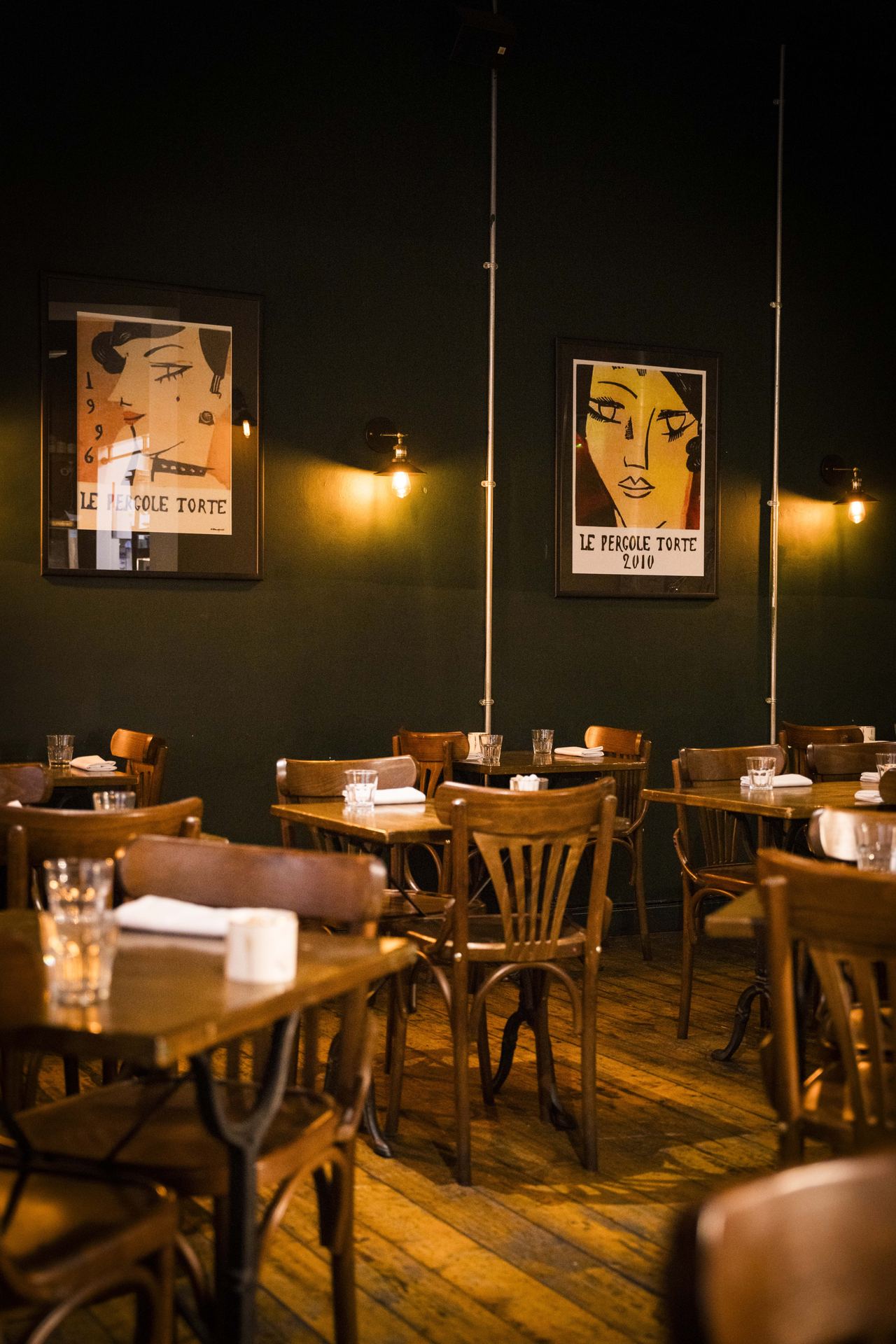The Queens dining room with wooden tables and warm lighting