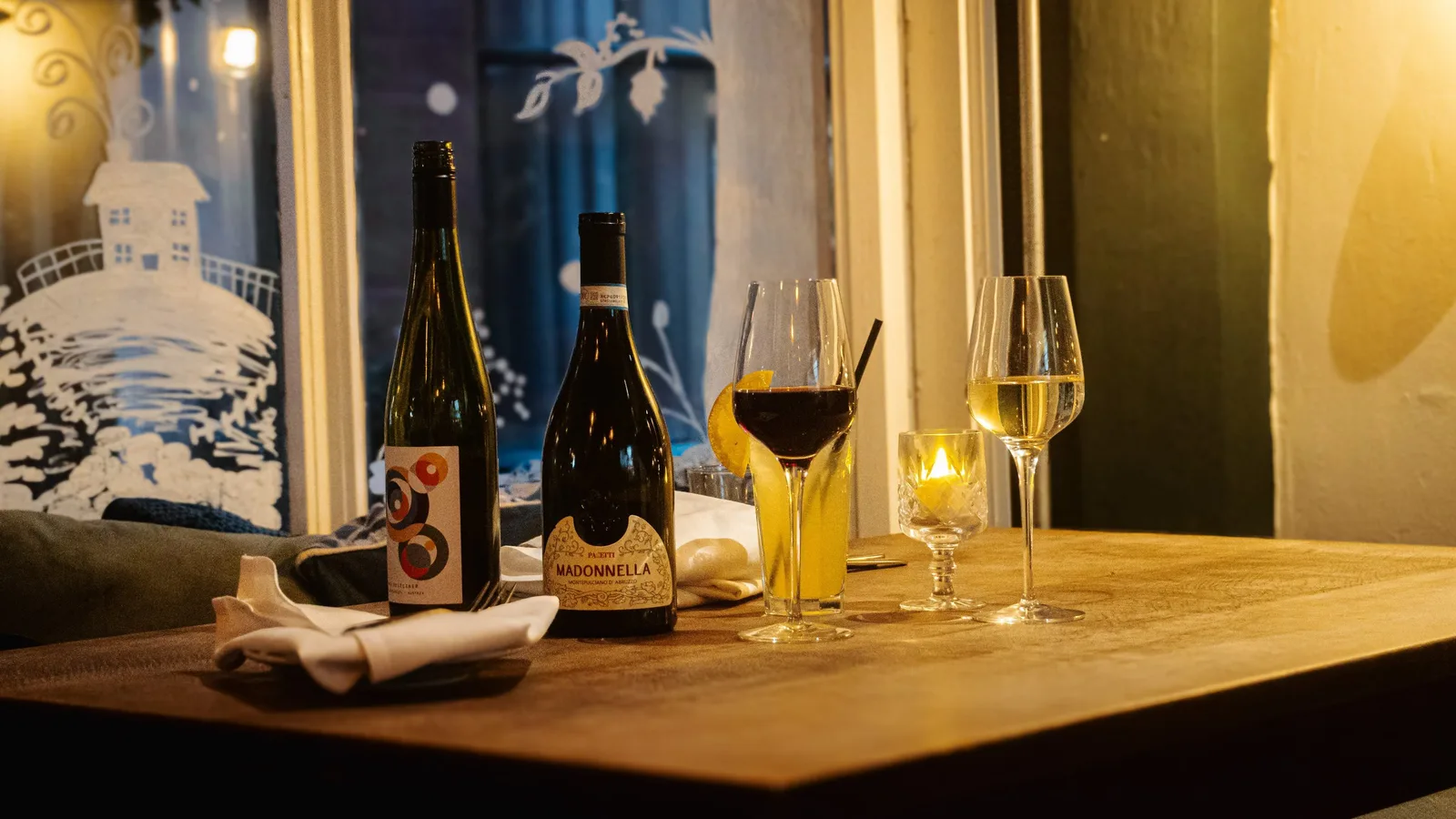 Wine glasses and bottles set on a Queens table